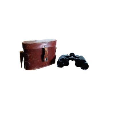 A set of classic analogue binoculars with a dark-coloured body, complete with a hard-shell carrying case in aged brown leather; available for hire for events, advertising, films and TV series