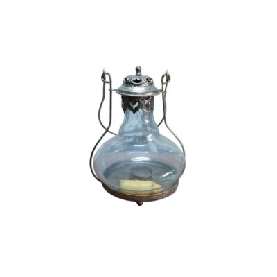 farol colgante de época, caracterizado por su cuerpo abombado de vidrio transparente, montura metálica inferior con soporte para vela y una cúpula superior perforada unida a un asa de alambre curvado para su suspensión alquiler para eventos, publicidad, peliculas y series