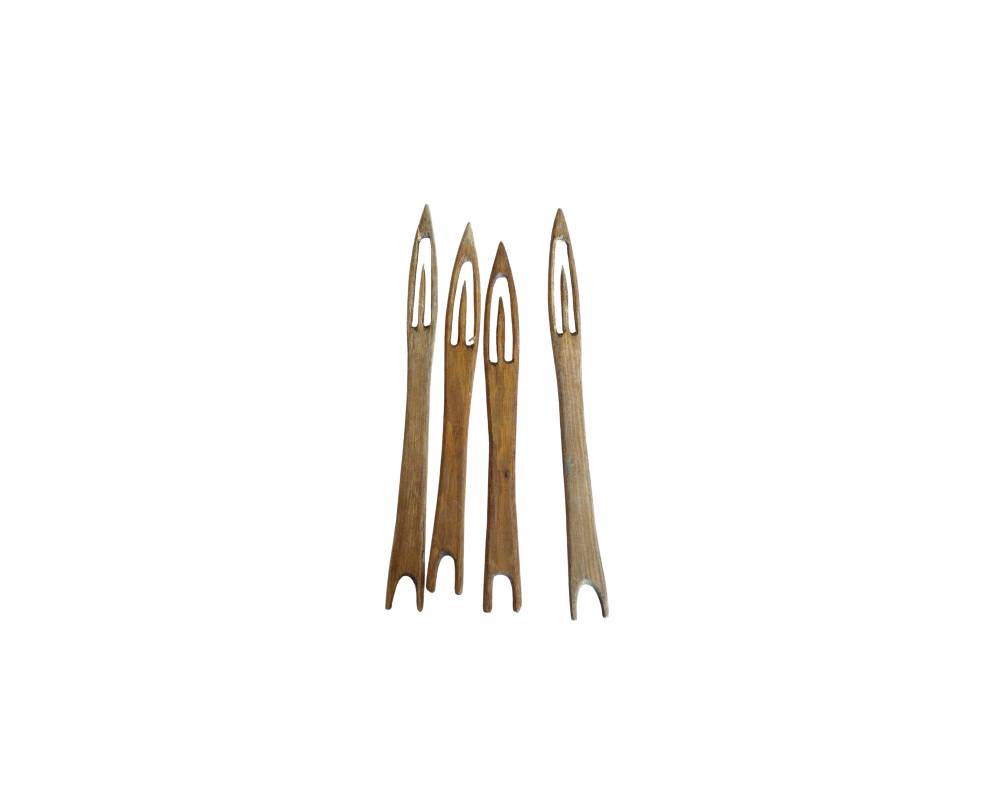 a set of handcrafted wooden shuttles, characterised by their pointed tip, elongated central eye and a notch at the base for collecting thread; available for hire for events, advertising, films and TV series