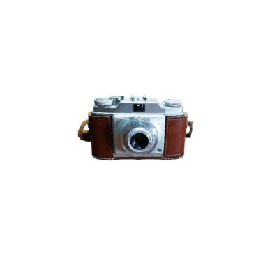 A classic analogue camera with a silver metal body, fitted with a detailed front lens and protected by a vintage brown leather case; available for hire for events, advertising, films and TV series