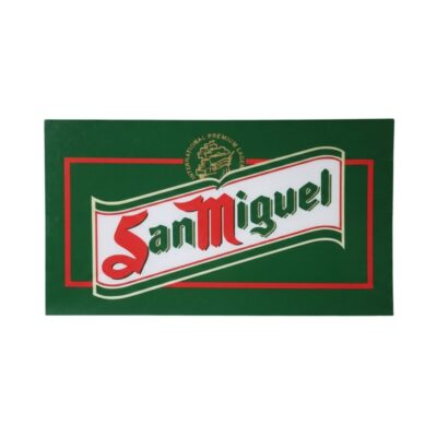 A rectangular plaque in landscape format with a dark green background and a red border, featuring the classic and distinctive logo of the ‘San Miguel’ beer brand in shades of red, white and green; available for hire for events, advertising, films and TV series