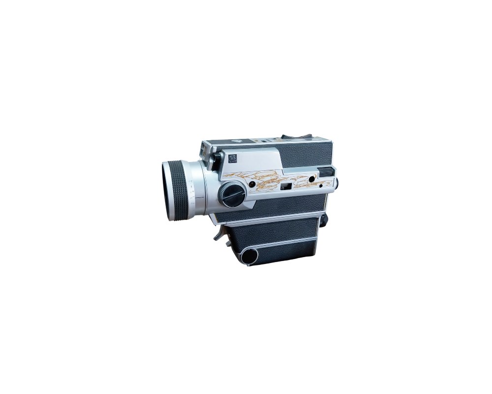A vintage compact analogue film camera, characterised by its silver-toned body combined with a dark textured finish featuring grooved decorative details, a lower grip and a prominent front lens; available for hire for events, advertising, films and TV series